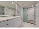 Modern bathroom featuring dual sink vanity, glass shower doors, and neutral walls at 165 Cummins Ne Ave, Port Charlotte, FL 33952