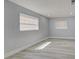 Empty bedroom with neutral walls, light-colored flooring, and natural light from two windows at 165 Cummins Ne Ave, Port Charlotte, FL 33952