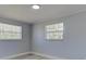 Bedroom with two bright windows and neutral paint at 165 Cummins Ne Ave, Port Charlotte, FL 33952