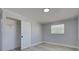 This light bedroom features a window, recessed lighting, and a closet with a white door for storage at 165 Cummins Ne Ave, Port Charlotte, FL 33952