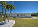 Well-kept home featuring lush landscaping and a neatly manicured front lawn at 165 Cummins Ne Ave, Port Charlotte, FL 33952