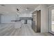 Eat-in kitchen featuring stainless appliances, white cabinetry, and views of living space at 165 Cummins Ne Ave, Port Charlotte, FL 33952