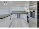 Bright modern kitchen with stainless steel appliances, white cabinets, and gray backsplash at 165 Cummins Ne Ave, Port Charlotte, FL 33952