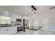 Modern kitchen with stainless steel appliances, granite countertops, and island at 165 Cummins Ne Ave, Port Charlotte, FL 33952