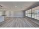 Spacious living room with lots of natural light, stylish floors, and new paint at 165 Cummins Ne Ave, Port Charlotte, FL 33952