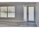 Living room with neutral paint, new flooring, and a glass door and window combo at 165 Cummins Ne Ave, Port Charlotte, FL 33952
