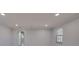 Spacious living room with neutral walls, recessed lights, window, and wood-look floors at 165 Cummins Ne Ave, Port Charlotte, FL 33952