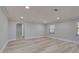 Spacious living room boasting recessed lights, light gray walls, and wood-look floors at 165 Cummins Ne Ave, Port Charlotte, FL 33952