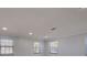 Bright living room featuring three windows, neutral walls, decorative molding, and recessed lighting at 165 Cummins Ne Ave, Port Charlotte, FL 33952