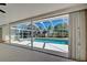 Covered patio with direct view of the screened-in pool and lush landscaping at 165 Cummins Ne Ave, Port Charlotte, FL 33952