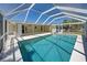 Screened-in pool with clear blue water and a spacious deck, perfect for relaxation at 165 Cummins Ne Ave, Port Charlotte, FL 33952