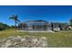 Backyard screened-in pool with lush landscaping in a charming single-Gathering home at 165 Cummins Ne Ave, Port Charlotte, FL 33952