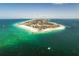 Stunning aerial view of a coastal community with turquoise waters and sandy beaches at 17 White Marsh Ln, Rotonda West, FL 33947