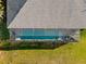 Aerial view of home showcasing the screened-in pool, lush lawn, and roof at 17 White Marsh Ln, Rotonda West, FL 33947