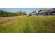 Large grassy backyard with green grass and a small drainage canal at 17 White Marsh Ln, Rotonda West, FL 33947