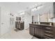 Well-lit bathroom with double sinks, contemporary fixtures, and bright vanity lighting at 17 White Marsh Ln, Rotonda West, FL 33947