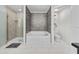 Beautifully designed bathroom features a shower, soaking tub, modern finishes, and plenty of light at 17 White Marsh Ln, Rotonda West, FL 33947