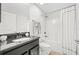 Bathroom featuring dark vanity, granite countertop, shower, and modern fixtures at 17 White Marsh Ln, Rotonda West, FL 33947