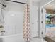 Bathroom featuring a white tub and shower combination and outdoor pool access at 17 White Marsh Ln, Rotonda West, FL 33947