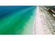 Beautiful shoreline view featuring crystal-clear turquoise waters meeting a pristine white sand beach at 17 White Marsh Ln, Rotonda West, FL 33947