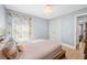 Well-lit bedroom featuring light blue walls, a chandelier, and light wood flooring at 17 White Marsh Ln, Rotonda West, FL 33947