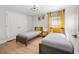 Bright bedroom featuring two twin beds with wooden frames and light wood floors at 17 White Marsh Ln, Rotonda West, FL 33947