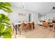 Open floor plan with a dining area, living room seating, light wood floors, and stylish decor at 17 White Marsh Ln, Rotonda West, FL 33947