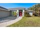 Attractive front entrance with a red door, manicured landscaping, and a stone pathway at 17 White Marsh Ln, Rotonda West, FL 33947