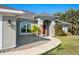 Close-up front exterior view with a red door and neatly manicured landscaping at 17 White Marsh Ln, Rotonda West, FL 33947