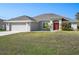 Charming single-story home featuring a well-manicured lawn and a two-car garage at 17 White Marsh Ln, Rotonda West, FL 33947