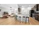 Open kitchen and living room with hardwood floors, granite countertops, stainless steel appliances and breakfast bar at 17 White Marsh Ln, Rotonda West, FL 33947