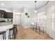 Bright eat-in kitchen features a breakfast bar, modern lighting and appliances, and neutral decor at 17 White Marsh Ln, Rotonda West, FL 33947