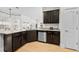 Spacious kitchen with stainless steel dishwasher, granite countertops, hardwood floors, and view of the back yard at 17 White Marsh Ln, Rotonda West, FL 33947