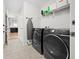 Bright laundry room with Samsung washer and dryer and shelving at 17 White Marsh Ln, Rotonda West, FL 33947