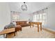 Cozy living room with a leather sofa, modern lighting, neutral decor, and sheer window curtains at 17 White Marsh Ln, Rotonda West, FL 33947