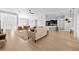 Open-concept living space with hardwood floors, bright walls, modern furniture, adjacent to a kitchen with a breakfast bar at 17 White Marsh Ln, Rotonda West, FL 33947
