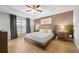 Comfortable main bedroom offers a decorative tray ceiling, fan, and warm neutral wall color at 17 White Marsh Ln, Rotonda West, FL 33947