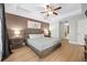 Comfortable main bedroom offers a decorative tray ceiling, fan, and warm neutral wall color at 17 White Marsh Ln, Rotonda West, FL 33947