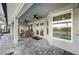 Covered outdoor patio with ceiling fans, dining table, and views of the backyard and pool at 17 White Marsh Ln, Rotonda West, FL 33947