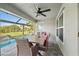 Inviting patio with outdoor dining set, a ceiling fan, and tranquil pool and yard views at 17 White Marsh Ln, Rotonda West, FL 33947