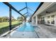 Gorgeous screened-in pool and spa with an outdoor seating area and landscaped backyard at 17 White Marsh Ln, Rotonda West, FL 33947