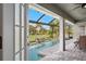 Inviting screened-in pool area offering a relaxing view of the manicured backyard at 17 White Marsh Ln, Rotonda West, FL 33947