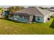 Backyard view of the pool and screened-in patio with lounge chairs at 17 White Marsh Ln, Rotonda West, FL 33947