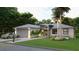 Charming single-story home featuring a well-manicured lawn, a two car garage and a welcoming entrance at 17196 Glenview Ave, Port Charlotte, FL 33954