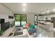 Bright living space flows into the kitchen, featuring a large window and contemporary decor at 17196 Glenview Ave, Port Charlotte, FL 33954