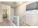 Bright hallway with staircase landing and views into a cheerful bedroom at 22375 Edgewater Dr # 149, Punta Gorda, FL 33980
