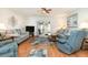 Comfortable living room featuring stylish decor, wood floors and open slider to the patio at 22375 Edgewater Dr # 149, Punta Gorda, FL 33980