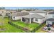 Well-maintained backyard featuring a black metal fence, green lawn, and a screened-in patio at 2486 Buckthorn Loop, North Port, FL 34289