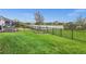 Well-maintained backyard featuring lush green grass and an elegant iron fence for added privacy at 2486 Buckthorn Loop, North Port, FL 34289