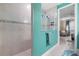 Modern bathroom featuring a tiled shower with glass enclosure and a view towards the bedroom at 2486 Buckthorn Loop, North Port, FL 34289